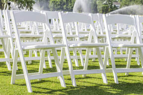 Picture of white chair rentals setup for outdoor reception party in Doral, FL